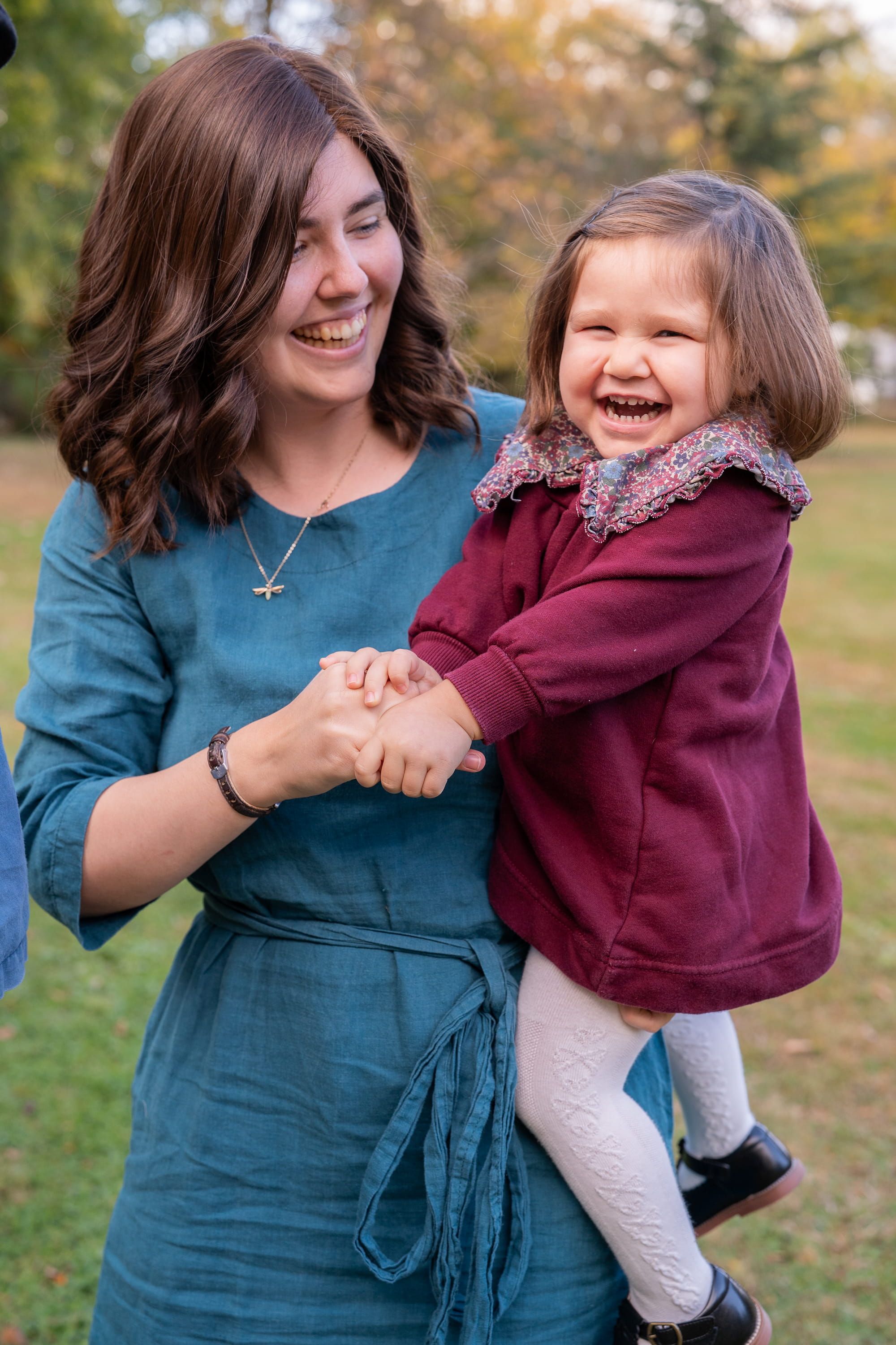 Mother and daughter laughing outdoors in fall